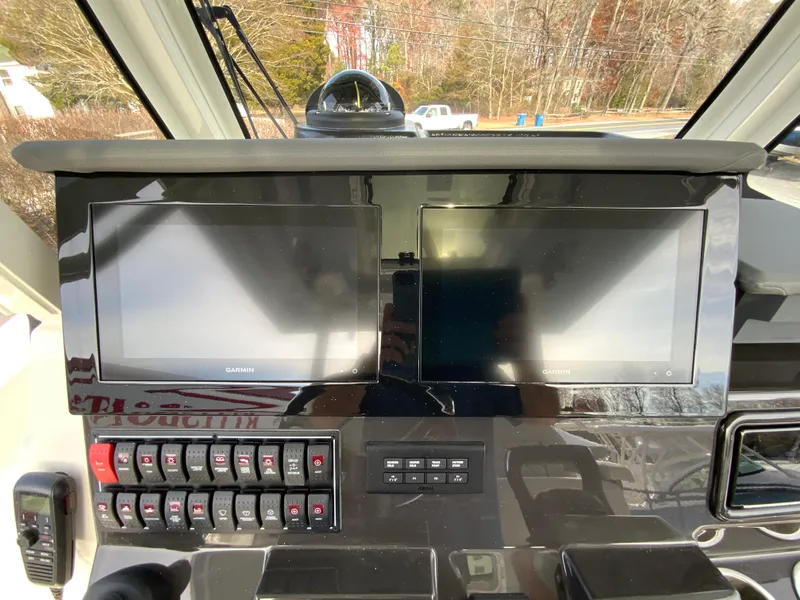 Slide: The Image of Dashboard of 2025 Pursuit S 288 Sport boat with dual screens and control panel. - 13