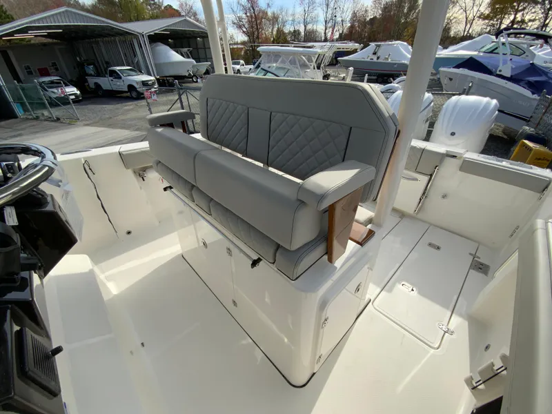 Slide: The Image of 2025 Pursuit S 288 Sport boat interior with cushioned seating and storage. - 15
