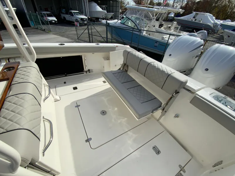 Slide: The Image of 2025 Pursuit S 288 Sport boat interior with cushioned seating and storage. - 18