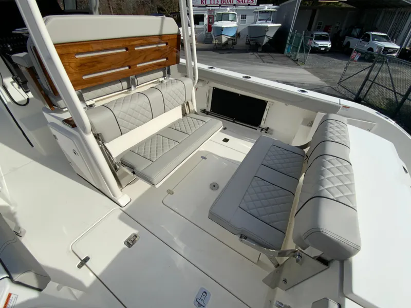 Slide: The Image of 2025 Pursuit S 288 Sport boat interior with cushioned seating and sleek design. - 19