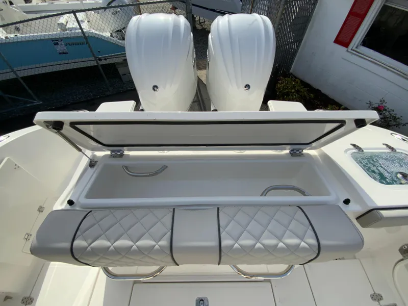 Slide: The Image of 2025 Pursuit S 288 Sport boat with open storage compartment and dual engines. - 20