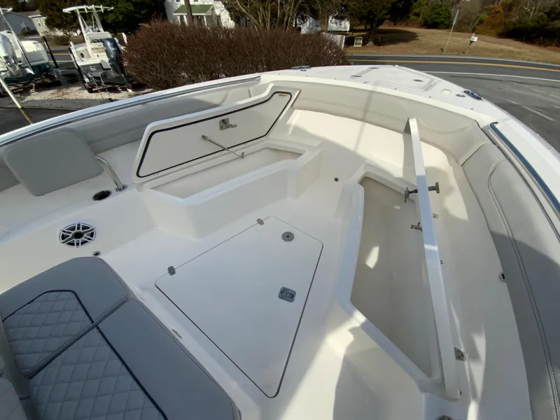 Slide: The Image of 2025 Pursuit S 288 Sport boat interior with open storage compartments and seating. - 27