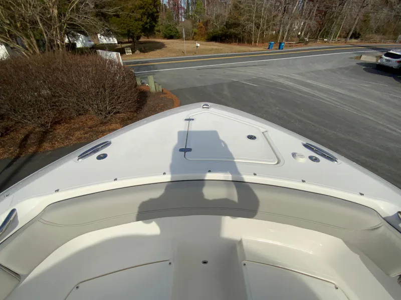 Slide: The Image of 2025 Pursuit S 288 Sport boat bow view in a driveway setting. - 29