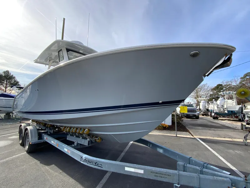 Slide: The Image of 2025 Pursuit S 288 Sport boat on trailer, parked outdoors. - 3