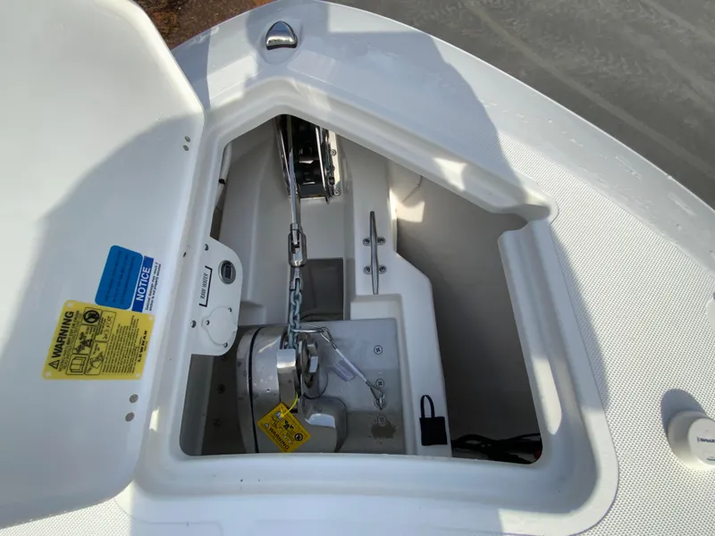 Slide: The Image of Anchor compartment of 2025 Pursuit S 288 Sport boat, featuring chain and winch. - 30