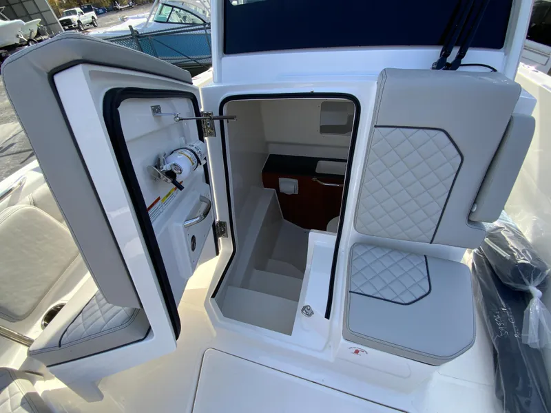 Slide: The Image of 2025 Pursuit S 288 Sport boat interior with open storage compartments and quilted seating. - 36