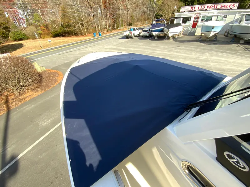 Slide: The Image of 2025 Pursuit S 288 Sport boat with blue cover at dealership. - 39