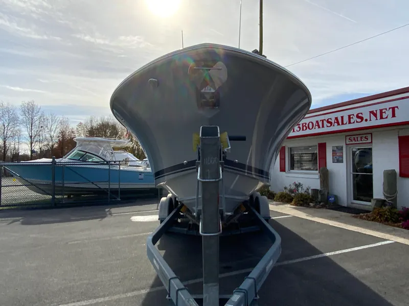 Slide: The Image of 2025 Pursuit S 288 Sport boat on trailer at dealership parking lot. - 4
