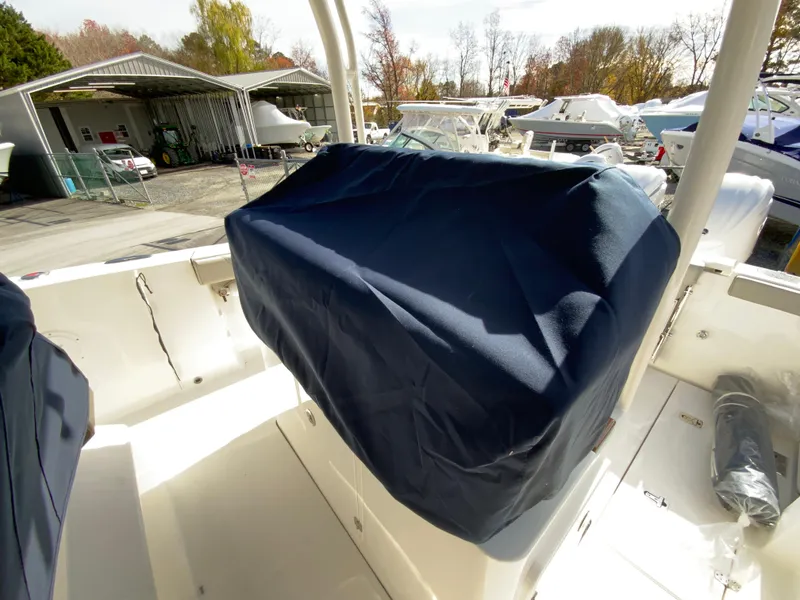 Slide: The Image of 2025 Pursuit S 288 Sport boat with covered seating area in a marina. - 41