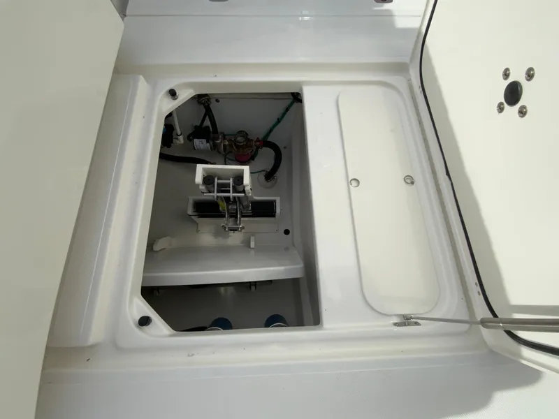 Slide: The Image of 2025 Pursuit S 288 Sport boat storage compartment with open hatch. - 44