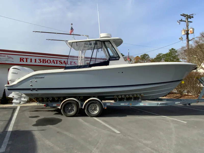 Slide: The Image of 2025 Pursuit S 288 Sport boat on trailer at dealership parking lot. - 45