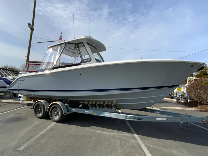Slide: The Image of 2025 Pursuit S 288 Sport boat on trailer in parking lot. - 46