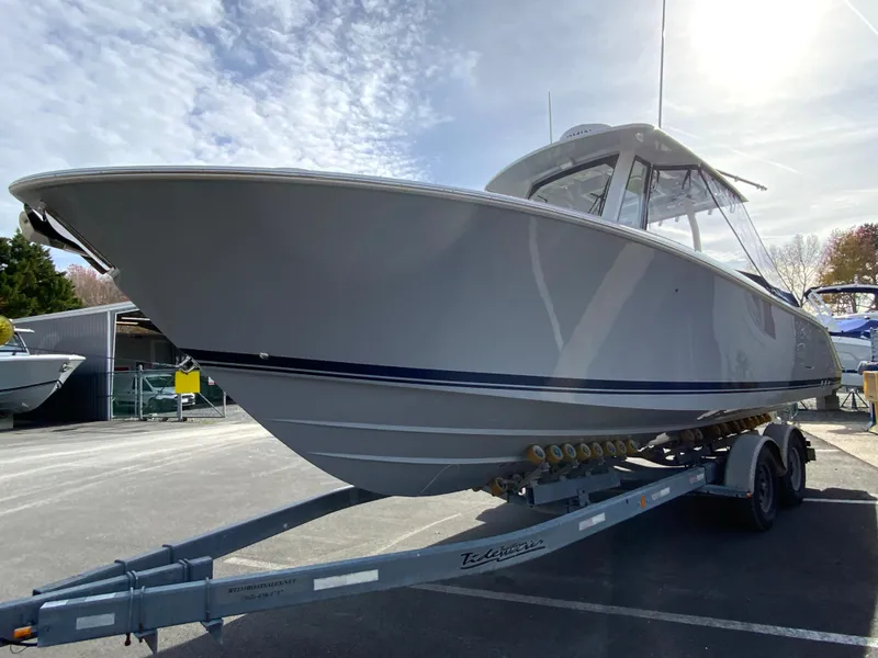 Slide: The Image of 2025 Pursuit S 288 Sport boat on trailer under sunny sky. - 48