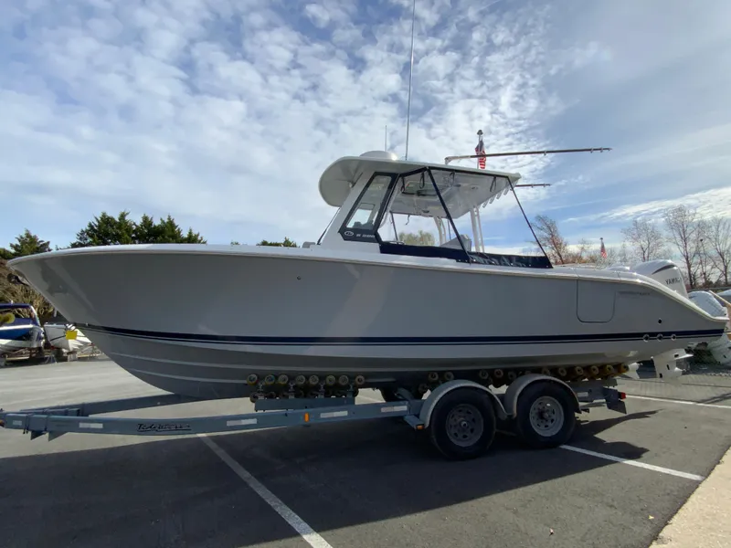 Slide: The Image of 2025 Pursuit S 288 Sport boat on trailer under cloudy sky. - 49
