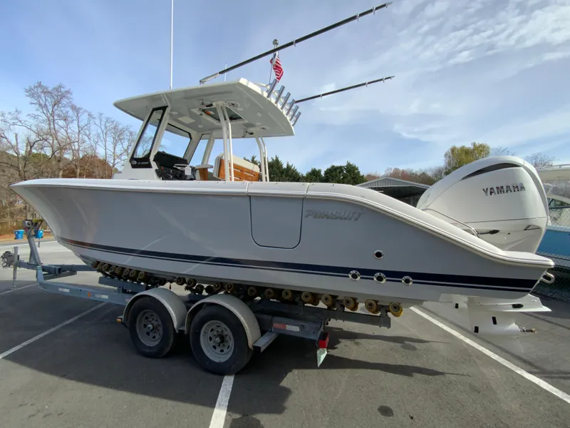 Slide: The Image of 2025 Pursuit S 288 Sport boat on trailer with Yamaha engine in parking lot. - 7