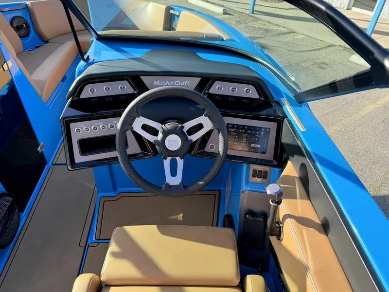 Slide: The Image of 2024 MasterCraft NXT23 boat interior with modern dashboard and steering wheel. - 12