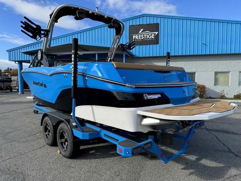 Slide: The Image of 2024 MasterCraft NXT23 boat in blue, parked at Prestige dealership. - 7