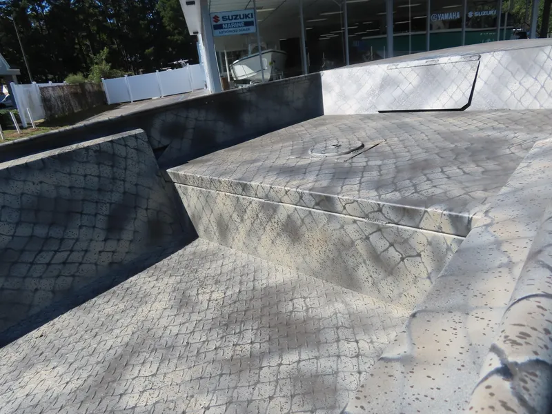 Slide: The Image of WeldBilt 1852 boat interior, 2025 model, with textured flooring and seating. - 12