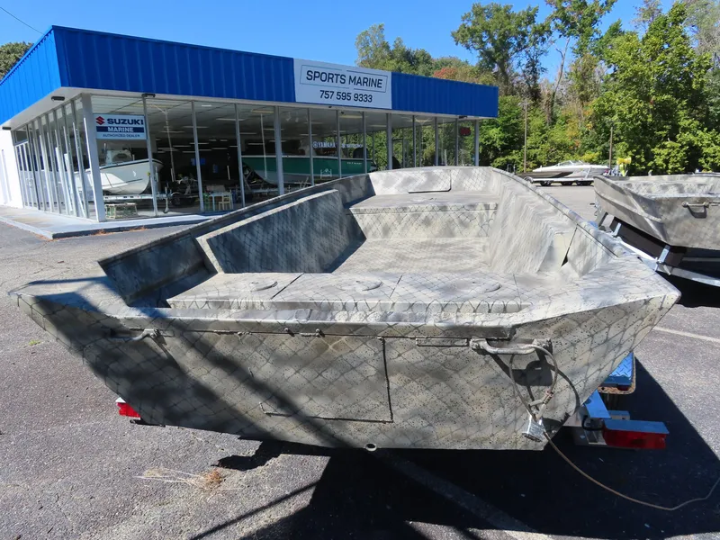 Slide: The Image of 2025 WeldBilt 1852 boat at Sports Marine dealership, parked outdoors. - 6