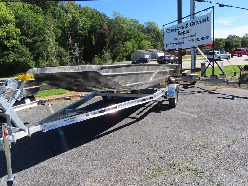 Slide: The Image of WeldBilt 1852 boat on trailer near fiberglass repair shop, 2025 model. - 9