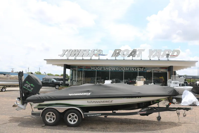 Slide: The Image of 2016 Phoenix 920 ProXP boat with advanced navigation equipment in a parking lot. - 11