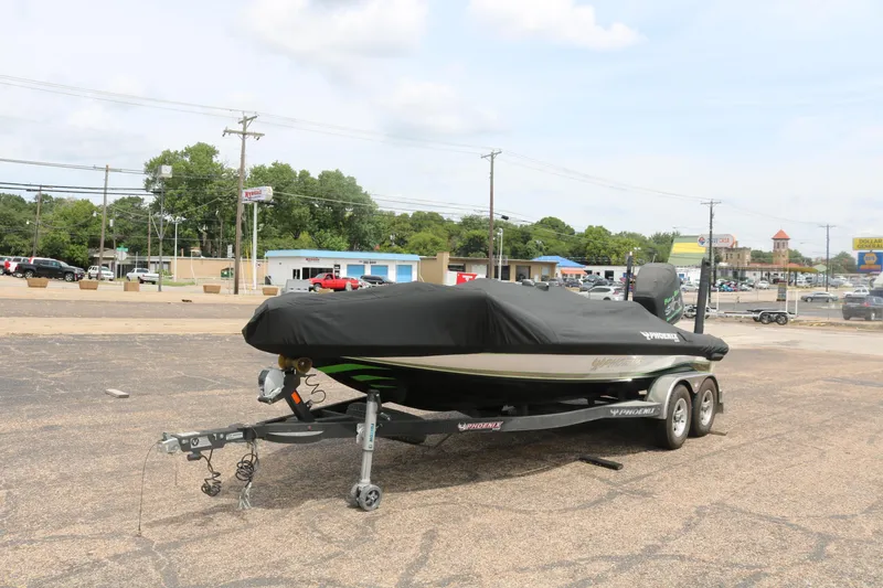 Slide: The Image of 2016 Phoenix 920 ProXP boat deck with open storage compartment and fishing equipment. - 13