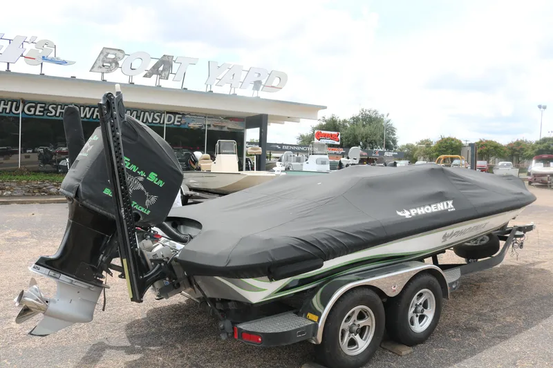 Slide: The Image of 2016 Phoenix 920 ProXP boat deck with logos and carpeted surface. - 16