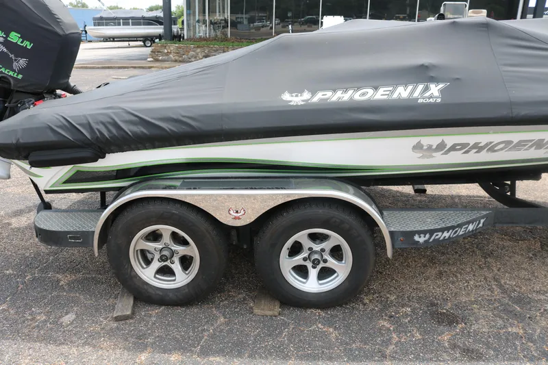 Slide: The Image of 2016 Phoenix 920 ProXP boat deck with open storage compartment. - 17