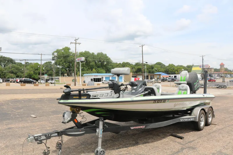 Slide: The Image of 2016 Phoenix 920 ProXP boat on trailer in parking lot under clear blue sky. - 2