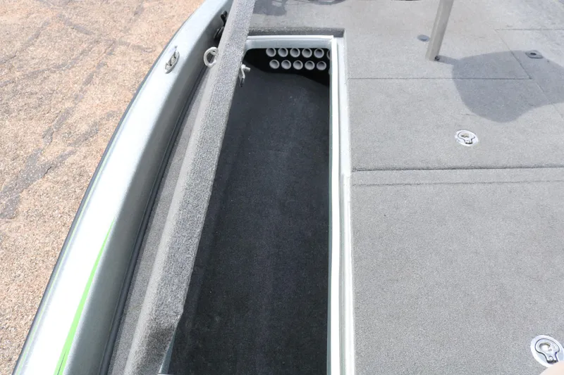 Slide: The Image of 2016 Phoenix 920 ProXP boat interior with green and gray seats, steering wheel, and storage compartments. - 25