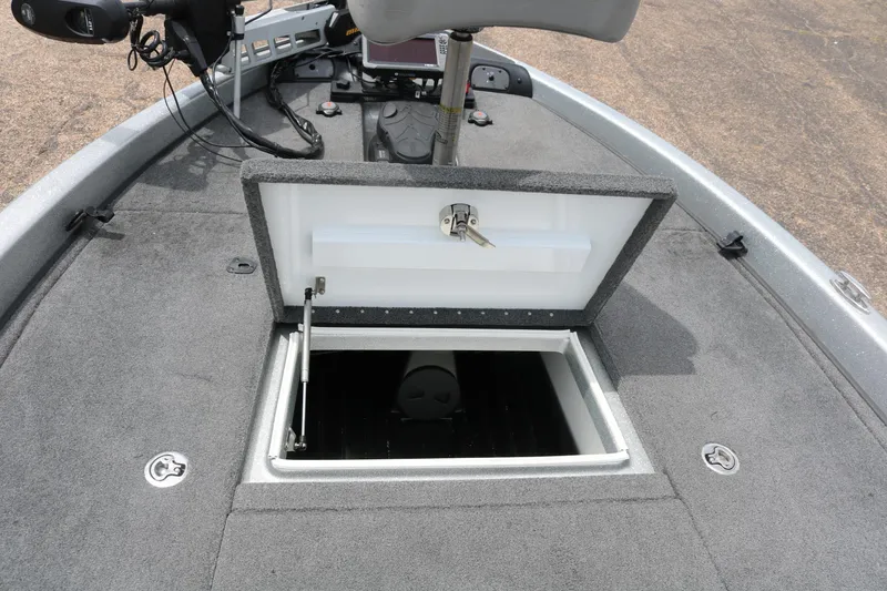 Slide: The Image of 2016 Phoenix 920 ProXP boat interior with green and gray seats, cup holders, and storage. - 26