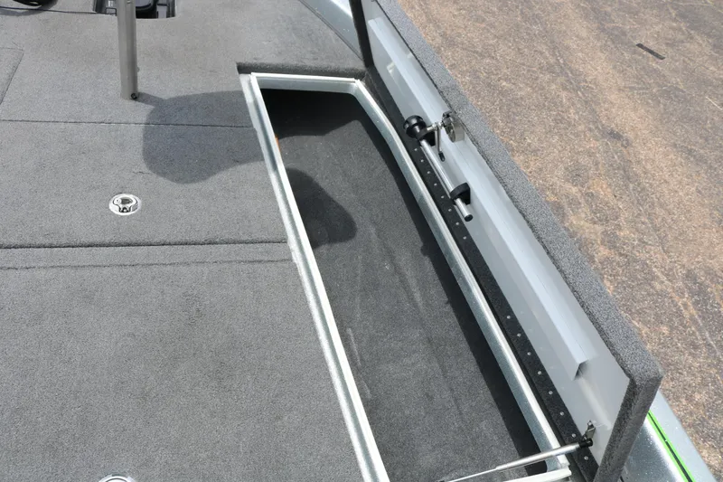 Slide: The Image of 2016 Phoenix 920 ProXP boat interior with green seats and storage compartment. - 27