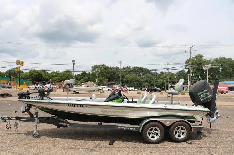 Slide: The Image of 2016 Phoenix 920 ProXP boat on trailer, parked outdoors under clear blue sky. - 3