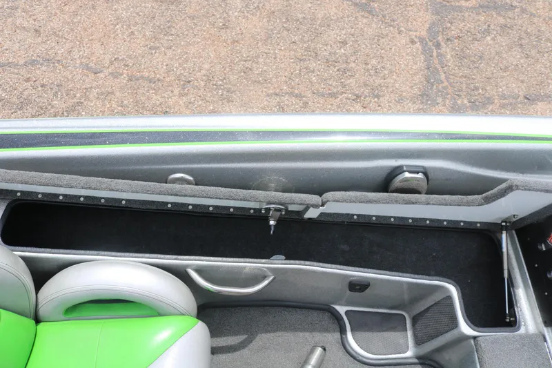 Slide: The Image of 2016 Phoenix 920 ProXP boat with open storage compartment on carpeted deck. - 30