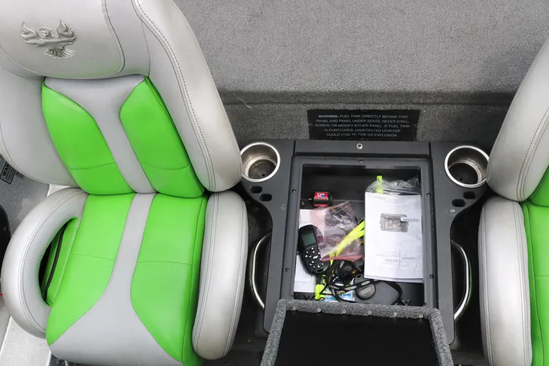 Slide: The Image of 2016 Phoenix 920 ProXP boat storage compartments with open lids and secure locks. - 32