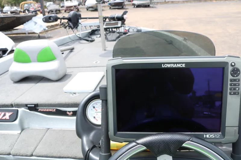 Slide: The Image of 2016 Phoenix 920 ProXP boat interior with green seats and steering console. - 38