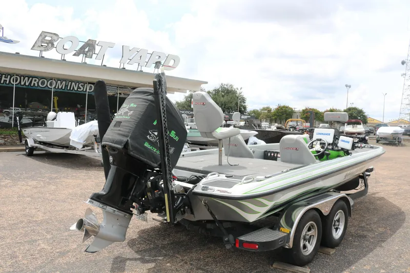 Slide: The Image of 2016 Phoenix 920 ProXP boat with green seats and Lowrance electronics in a parking lot. - 8