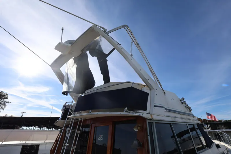 Slide: The Image of 1988 Bayliner 3818 Motoryacht with flybridge under clear blue sky. - 5