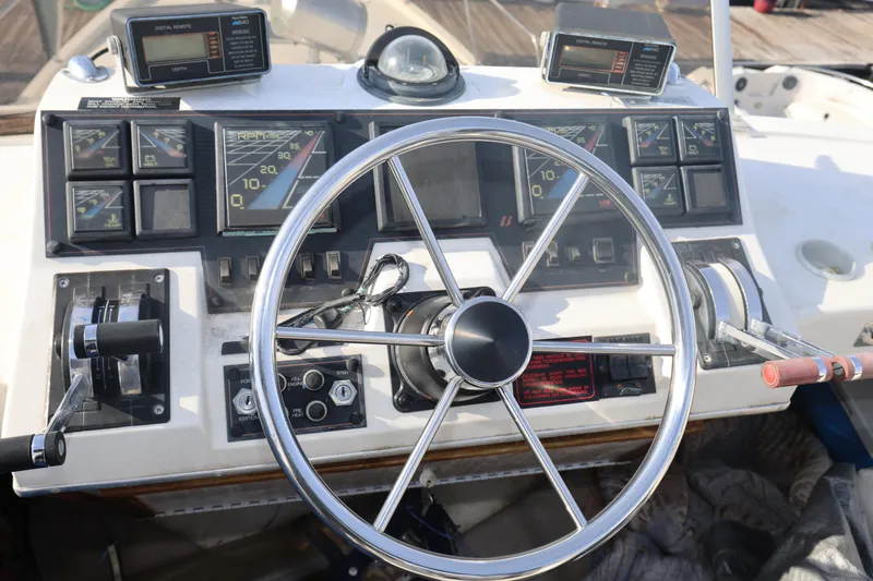 Slide: The Image of 1988 Bayliner 3818 Motoryacht helm with steering wheel and instrument panel. - 7