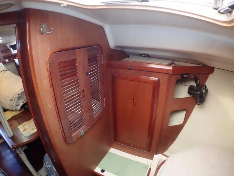 Slide: The Image of Interior of 1991 Hunter Legend 37.5 sailboat with wooden cabinetry and compact design. - 32