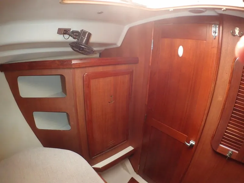 Slide: The Image of Interior of 1991 Hunter Legend 37.5 sailboat with wooden cabinetry and cozy design. - 33
