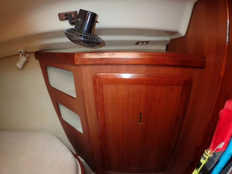 Slide: The Image of Interior of 1991 Hunter Legend 37.5 sailboat with wooden cabinetry and fan. - 34