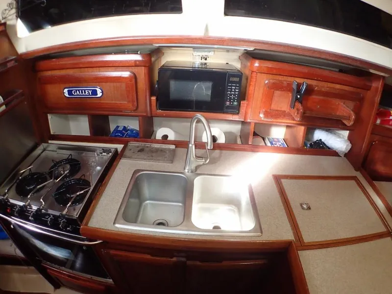 Slide: The Image of Galley kitchen in 1991 Hunter Legend 37.5 sailboat with sink, stove, and microwave. - 35