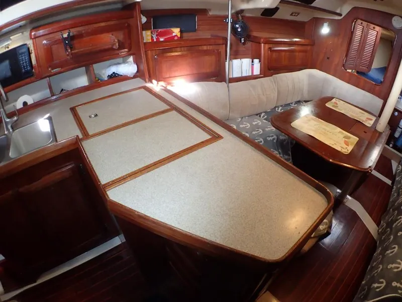 Slide: The Image of Interior of 1991 Hunter Legend 37.5 sailboat with wooden cabinetry and seating area. - 36