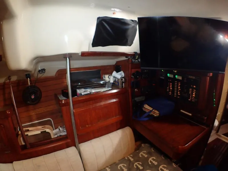Slide: The Image of Interior of 1991 Hunter Legend 37.5 sailboat with wood paneling and navigation equipment. - 41