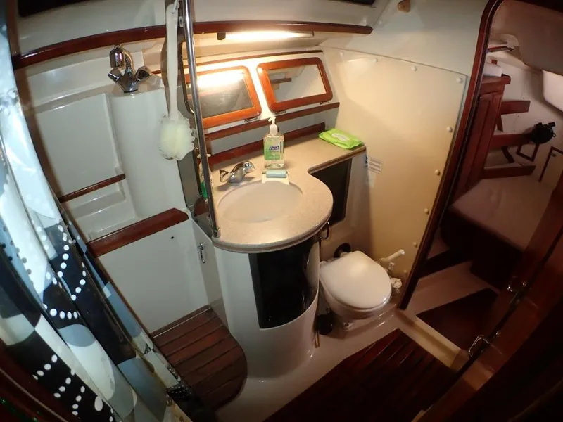 Slide: The Image of 1991 Hunter Legend 37.5 yacht bathroom with shower, sink, and toilet. - 42