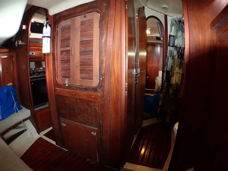 Slide: The Image of Interior of 1991 Hunter Legend 37.5 sailboat with wooden cabinetry and cozy layout. - 44