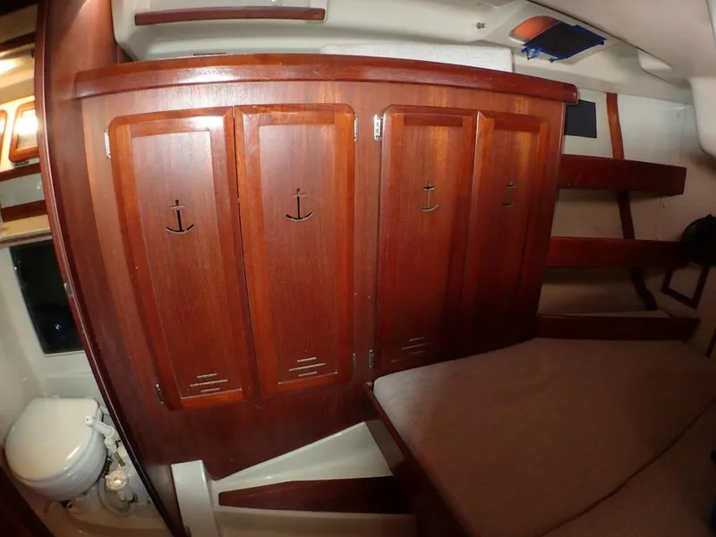 Slide: The Image of Interior of 1991 Hunter Legend 37.5 sailboat with wooden cabinets and compact bathroom. - 46
