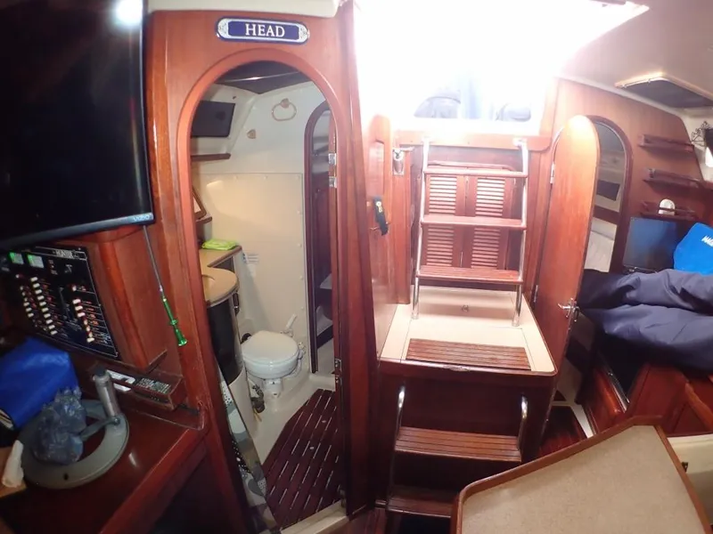 Slide: The Image of Interior of 1991 Hunter Legend 37.5 sailboat, featuring wooden cabinetry and compact bathroom. - 49