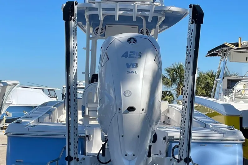 Slide: The Image of 2023 Robalo 266 Cayman SD boat with powerful 425 V8 engine, docked under clear blue sky. - 3